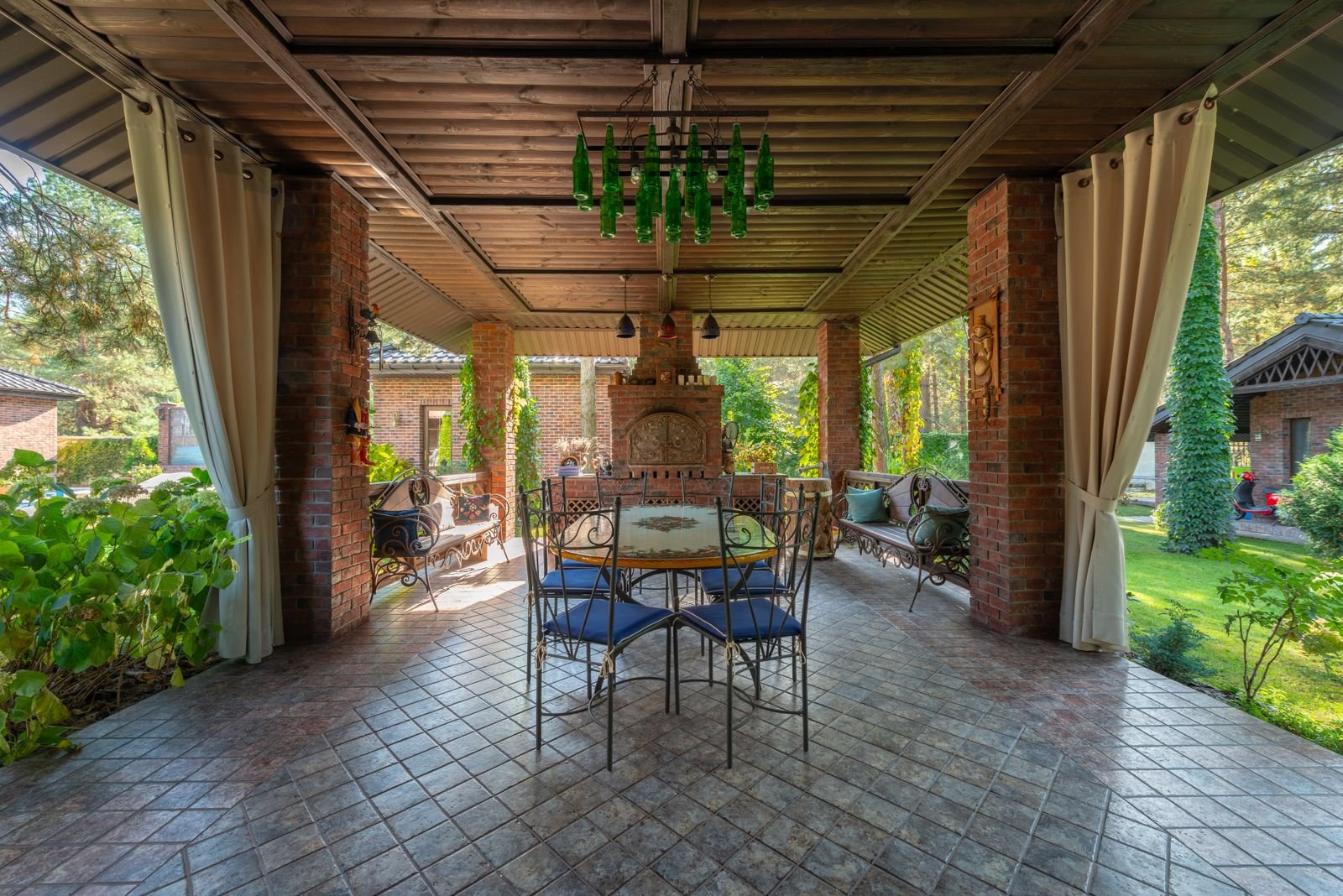 Covered loggia with brick columns and a tiled floor
